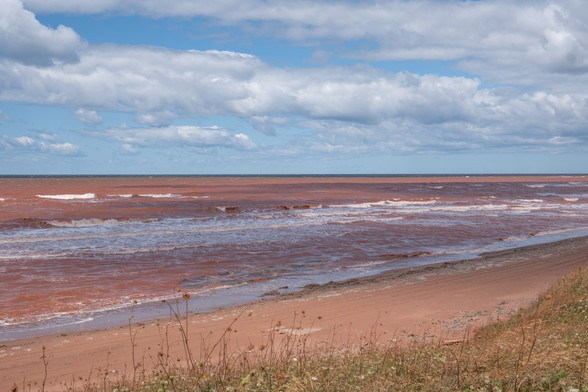A Prince Edward Island oceanfront shot, with the sand and water being surprisingly red.