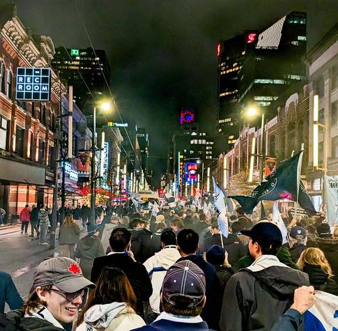 Whitecaps fans parade cheerfully down Granville, singing dopey songs and chanting dopey chants. 